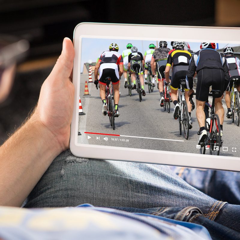 Man watching sports on tablet. Football and soccer game live str Man watching sports on tablet. Football and soccer game live stream and video player on screen. Pay per view (PPV) service. Replay or highlights broadcast. Lazy person relaxing. Couch potato.